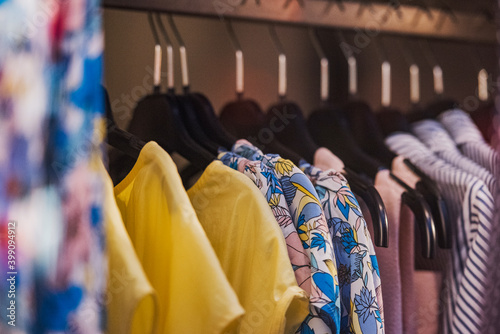 Women clothing on hangers in a mall - shopping in mall concept