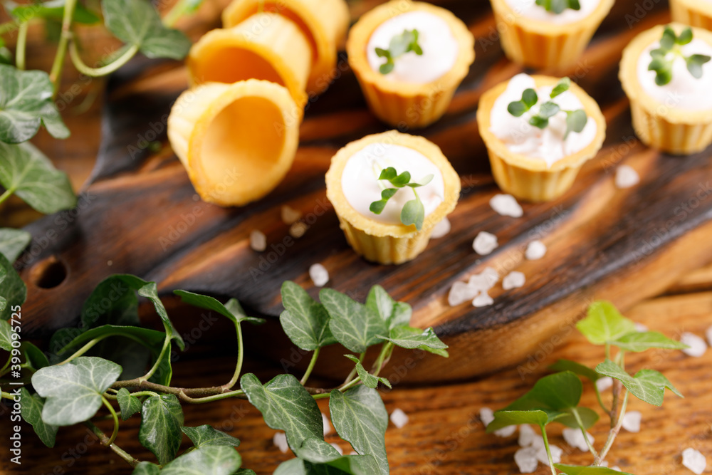 Fototapeta premium Canapes with light cream filling. Still life with microgreens. The concept of an appetizing snack.