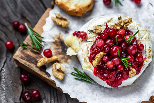 Baked cheese Camembert with cranberries and nuts. Gourmet appetizer. Breakfast, Food recipe background photo