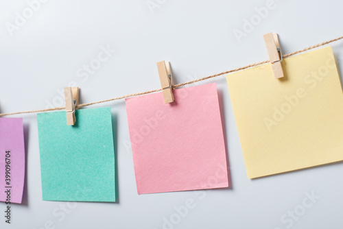 Note papers on thread agaist white background