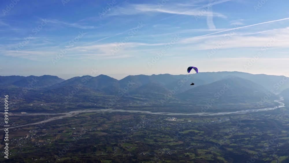 colorful paraglider in air with Piave river in background, adventure sport colorful paraglider in air with Piave river in background, adventure sport