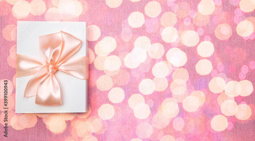 white gift box with bow on bokeh background. Baner