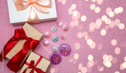 Gift boxes and candies on bokeh background. Flat layout. Copy space