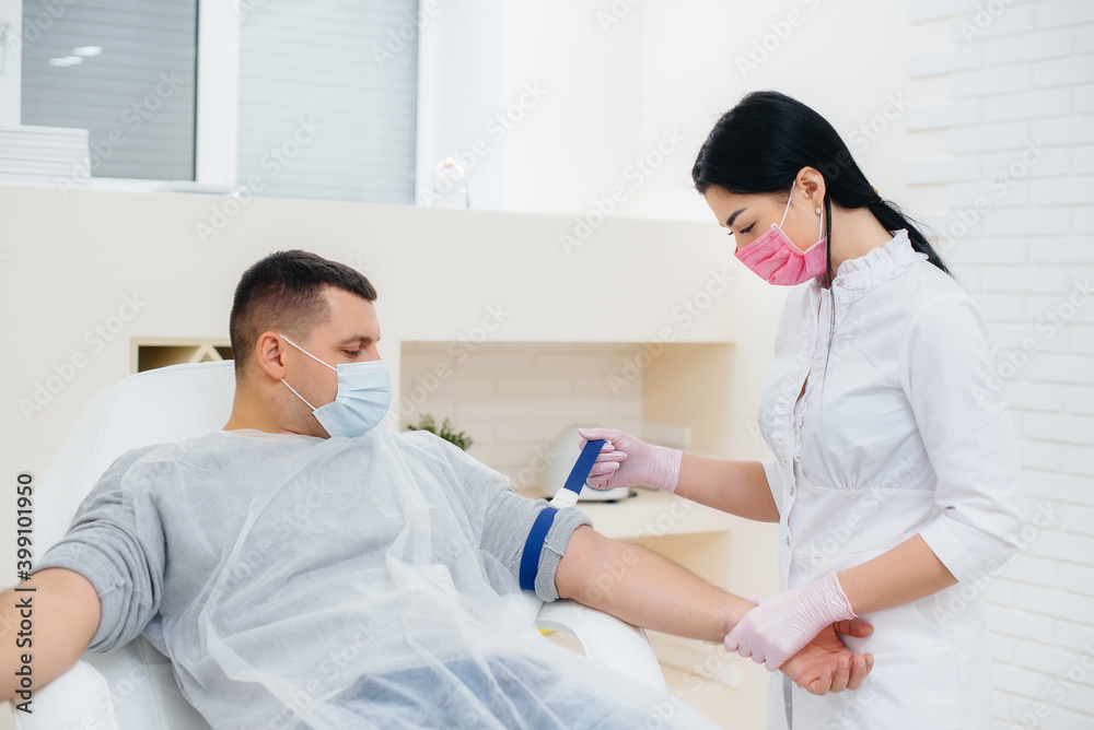 A man's blood is taken from a vein for analysis and testing for viruses. The formation of the immune system and antibodies. A man's blood is taken from a vein for analysis and testing for viruses. The formation of the immune system and antibodies.