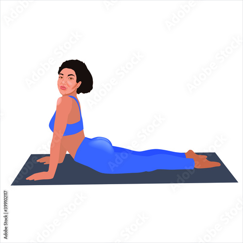 Beautiful sporty black woman practices yoga asana bhujangasana - cobra pose. Woman workout fitness, aerobic and exercises. Healthy lifestyle concept. 