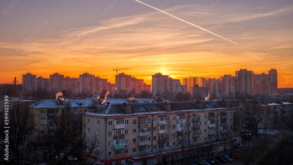 Beautiful photo of morning sunrise in the city. Orange sunlight and beauty sky under the city buildings.