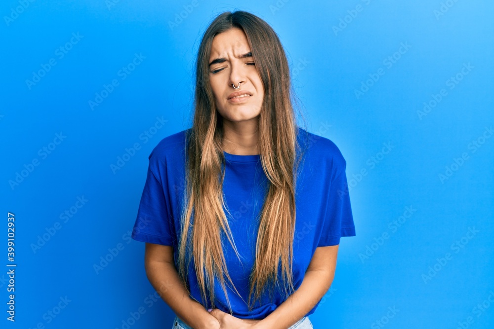 Young hispanic woman wearing casual clothes with hand on stomach because nausea, painful disease feeling unwell. ache concept. Young hispanic woman wearing casual clothes with hand on stomach because nausea, painful disease feeling unwell. ache concept.