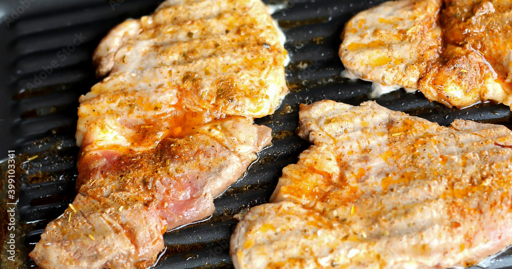 Outdoor barbecue party. Closeup of meat roasting on electric grill.