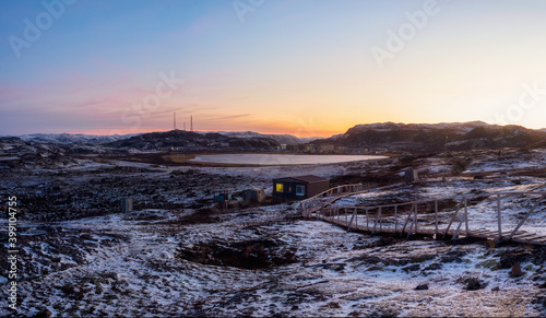 Magenta winter dawn. Panoramic icy landscape and mountains in the Russian village Teriberka