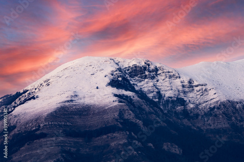 Stunning view of a snow capped mountain range during a dramatic sunset. Campocatino, Frosinone, Italy.