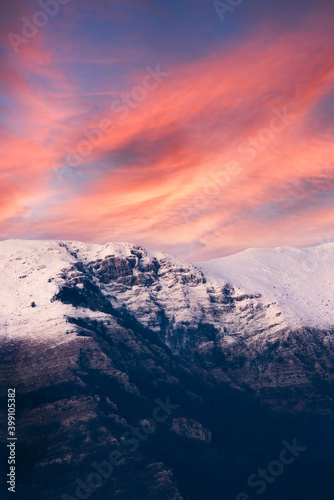 Stunning view of a snow capped mountain range during a dramatic sunset. Campocatino, Frosinone, Italy.