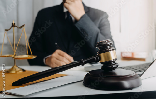 Business and lawyers discussing contract papers with brass scale on desk in office. Law  legal services  advice  justice and law concept picture with film grain effect