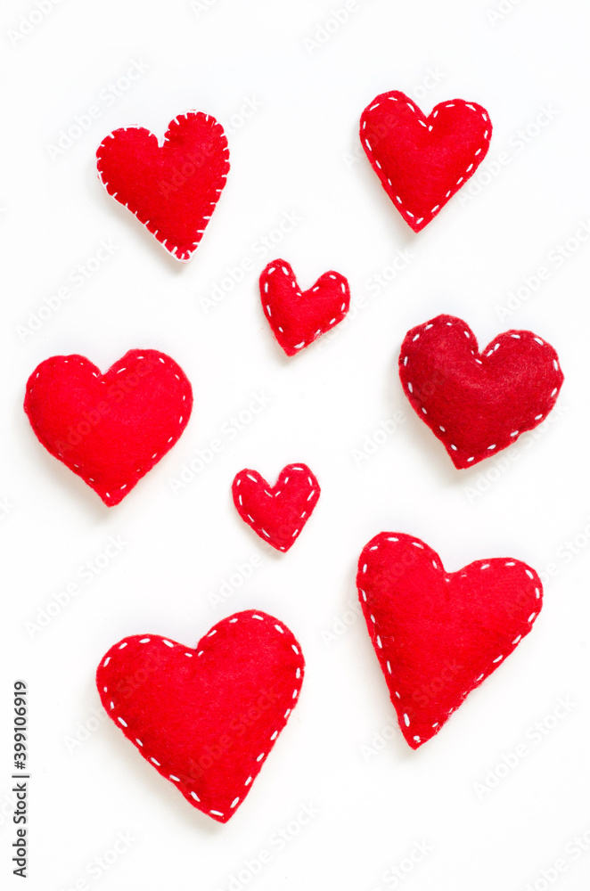 Red felt hearts set. Handmade love symbol with white stitches on white. 