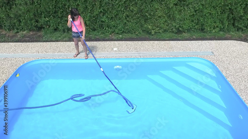 Cleaning the home pool.