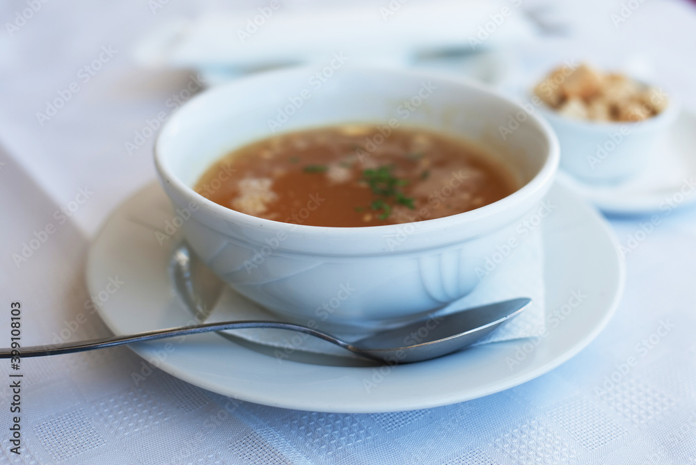 traditional chicken soup served in a bowl over white background traditional chicken soup served in a bowl over white background