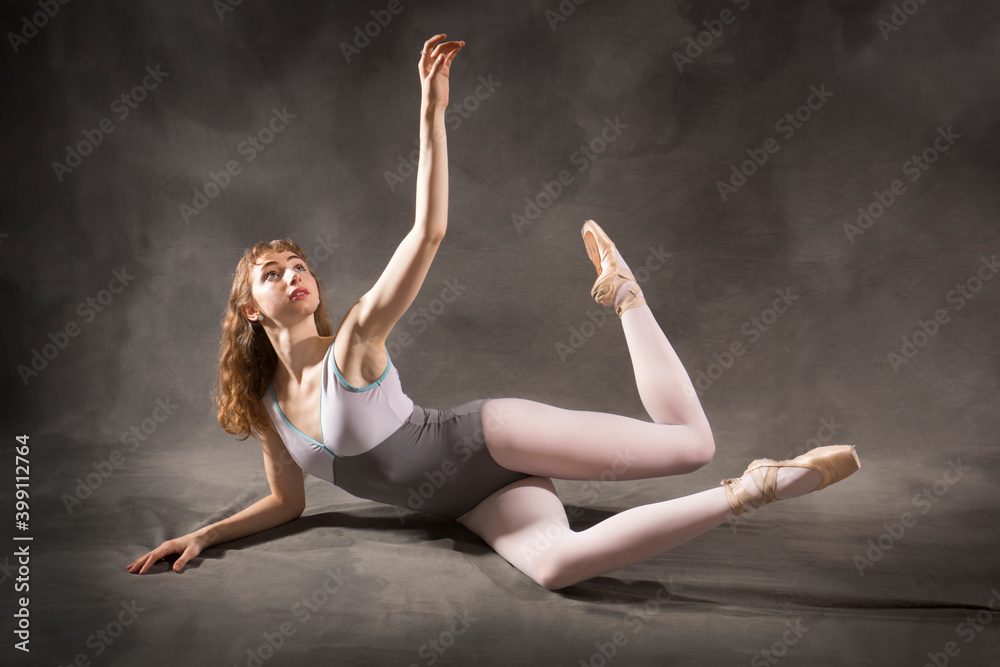 Young woman dancing on the floor in the studio.