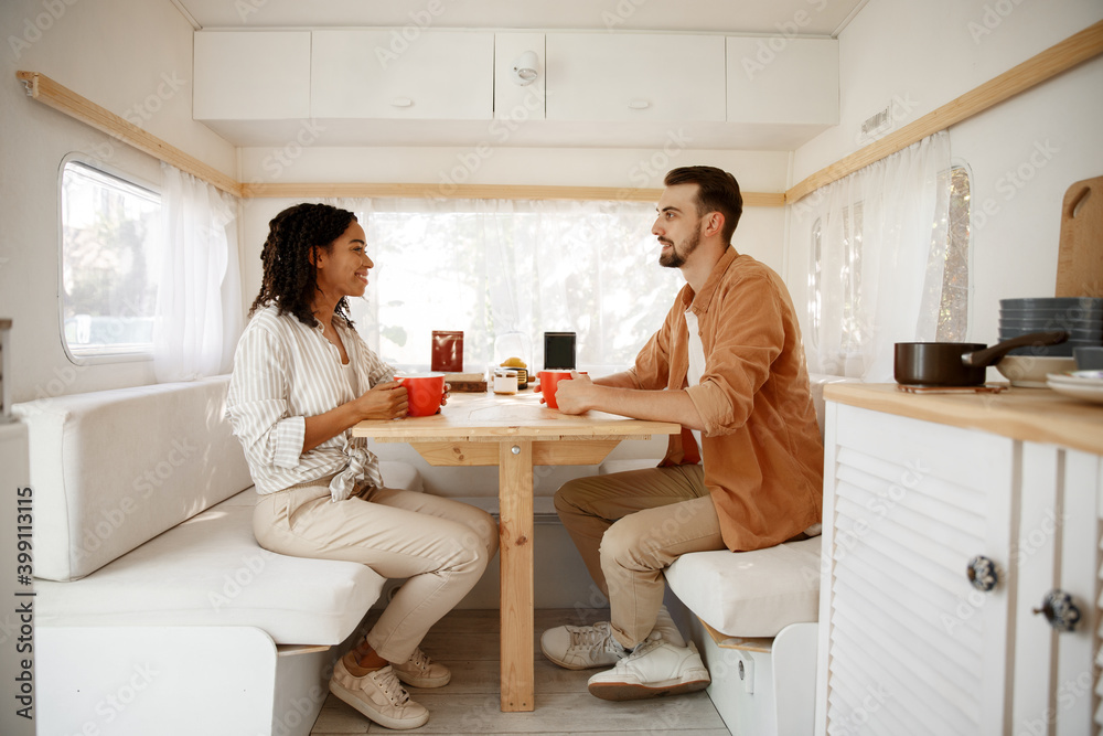 Love couple having breakfast in rv, camping Love couple having breakfast in rv, camping