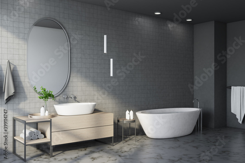 Freestanding bath with mirror in comfortable gray bathroom interior