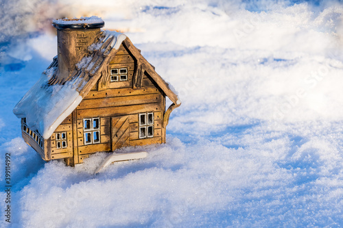 Ceramic model of a house in snow. Holiday concept for Christmas  New Year  and sweet home with copy space