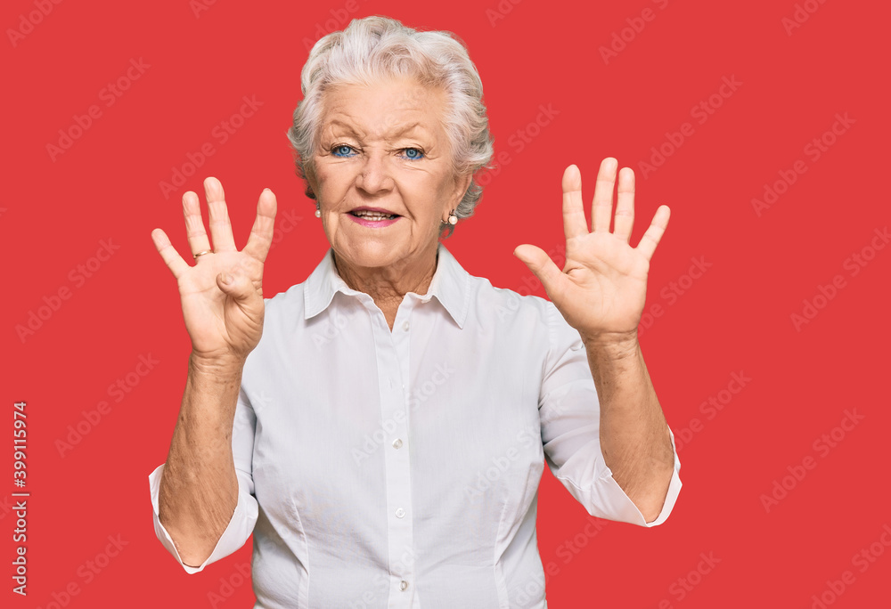 Senior grey-haired woman wearing casual clothes showing and pointing up with fingers number nine while smiling confident and happy. Senior grey-haired woman wearing casual clothes showing and pointing up with fingers number nine while smiling confident and happy.