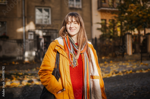 sunny portrait of a young woman in autumn in the park outdoors