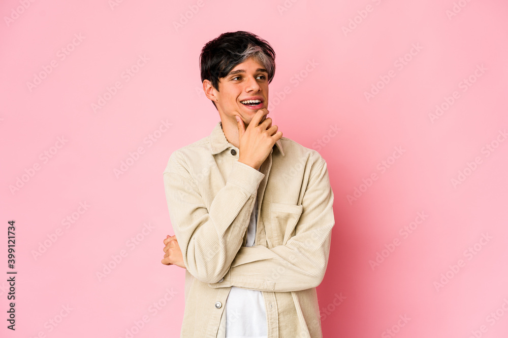 Young skinny hispanic man relaxed thinking about something looking at a copy space.