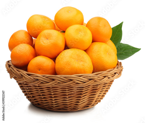 Fresh tangerines in a basket isolated on white