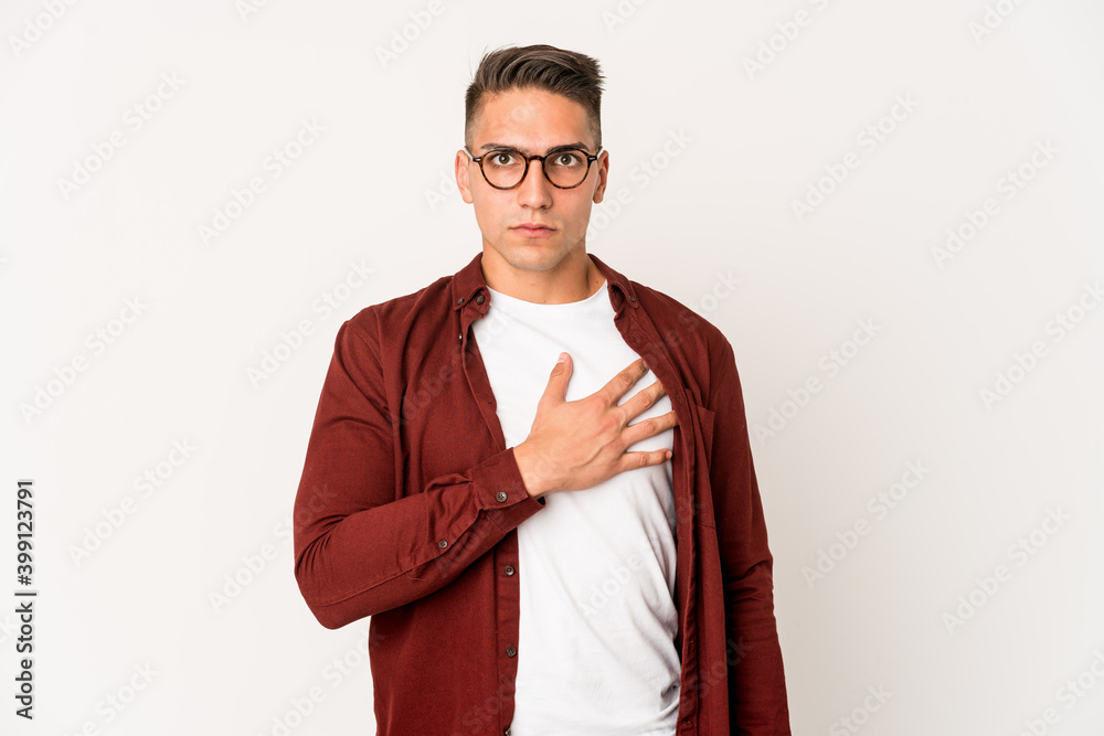 Young caucasian handsome man isolated taking an oath, putting hand on chest. Young caucasian handsome man isolated taking an oath, putting hand on chest.