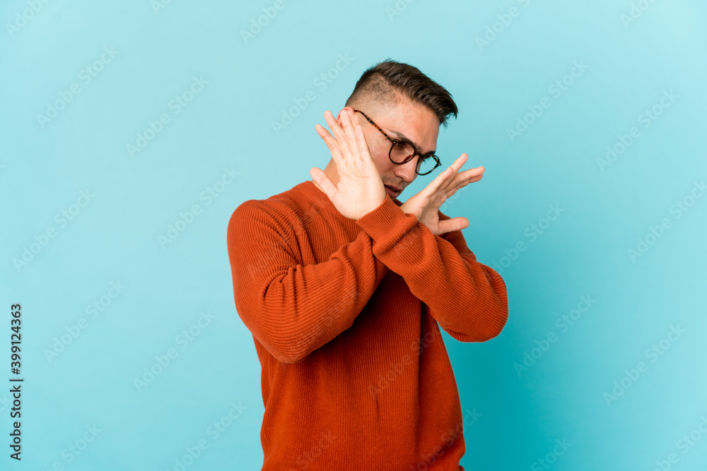 Young caucasian handsome man isolated keeping two arms crossed, denial concept. Young caucasian handsome man isolated keeping two arms crossed, denial concept.