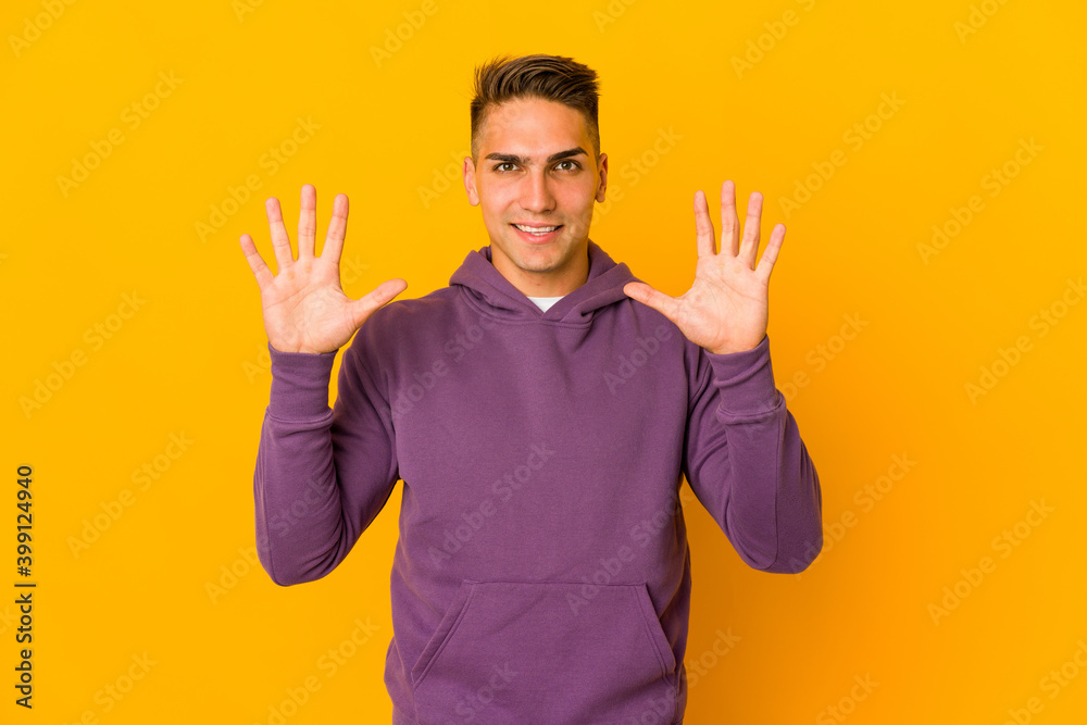 Young handsome caucasian man isolated showing number ten with hands. Young handsome caucasian man isolated showing number ten with hands.