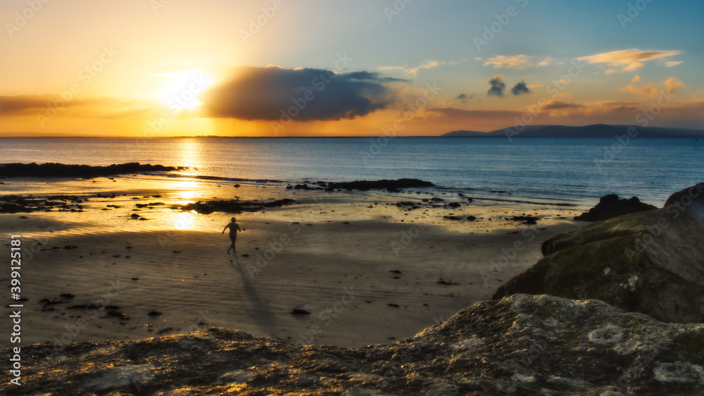 Beautiful morning orange sunrise at Salthill beach in Galway city, Ireland 
