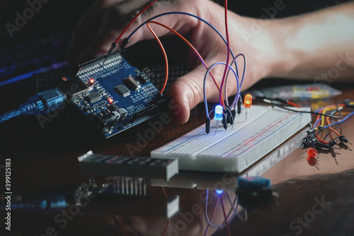 Man learns the basics of programming microprocessors close up. photo