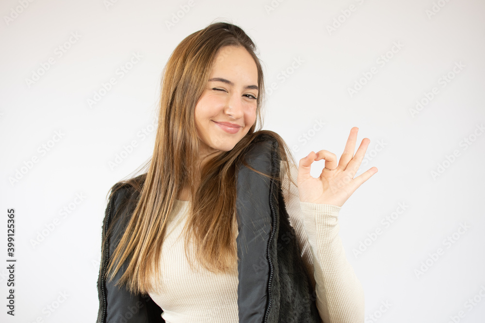 Success pretty young woman showing hand okay sign over white background Success pretty young woman showing hand okay sign over white background