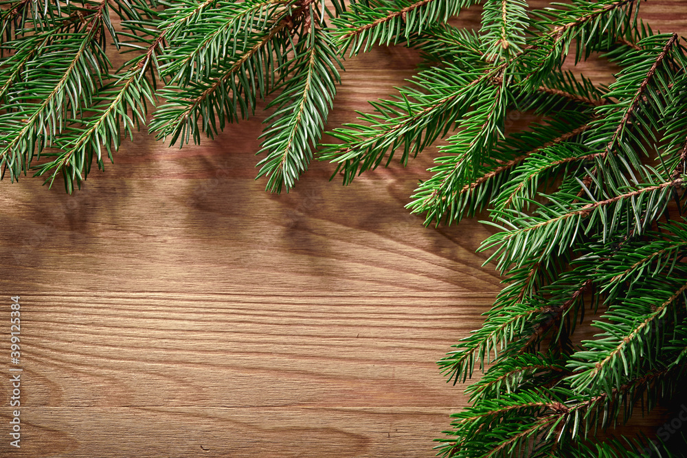 Christmas card - Christmas tree branches on the wooden background Christmas card - Christmas tree branches on the wooden background