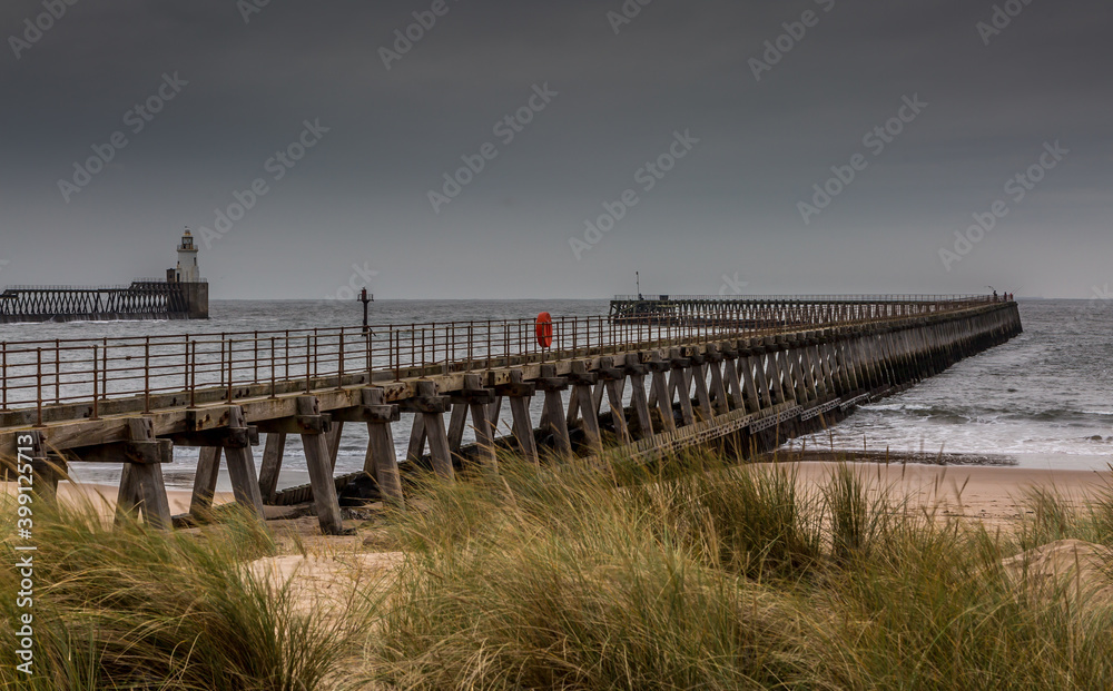 Morning at Blyth beach in Northumberland, England, with the old wooden Pier stretching out to the North Sea