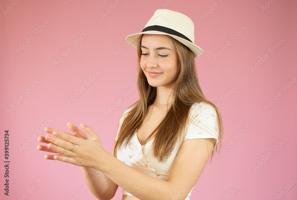 Young pretty girl feeling happy and successful, smiling and clapping hands, saying congratulations with an applause against pink wall