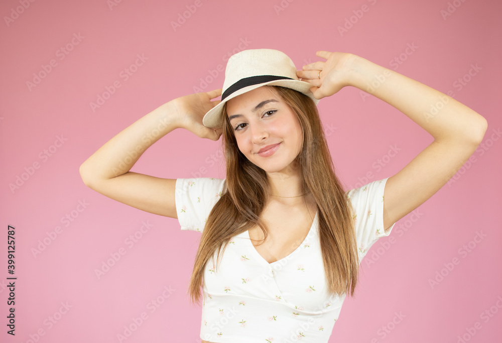 Portrait of a happy young girl wearing straw hat isolated over pink background Portrait of a happy young girl wearing straw hat isolated over pink background