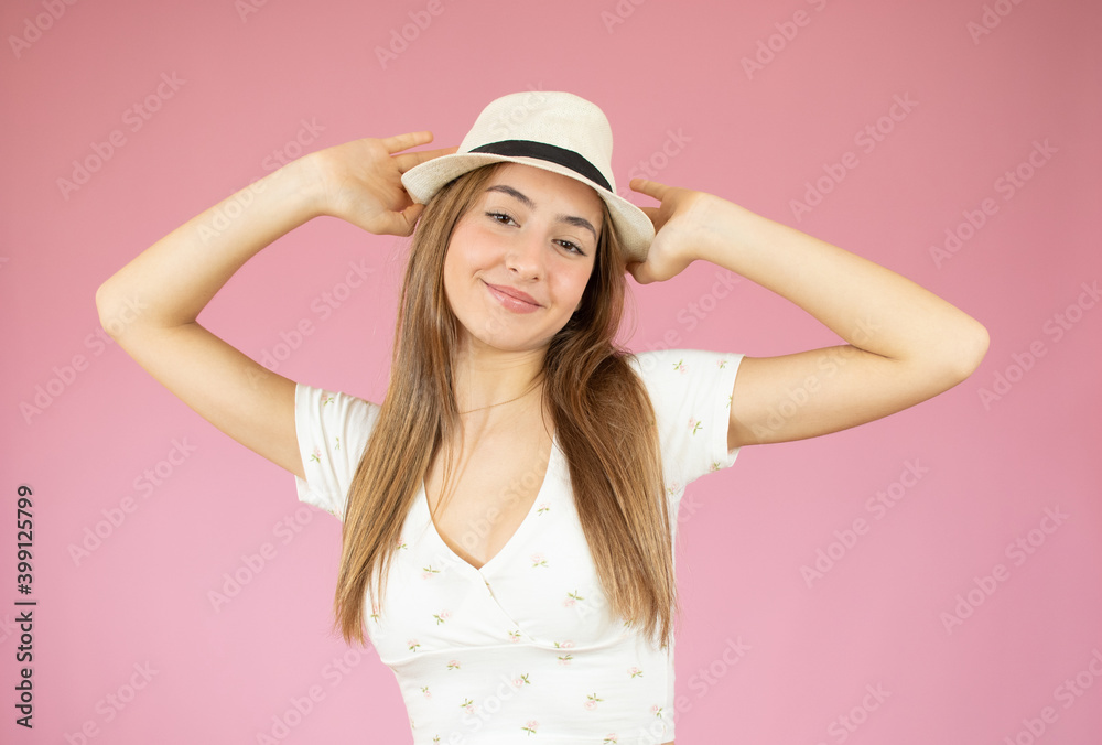 Portrait of a happy young girl wearing straw hat isolated over pink background Portrait of a happy young girl wearing straw hat isolated over pink background