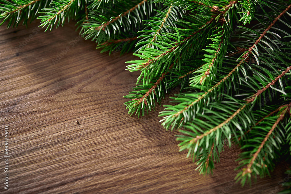 Christmas card - Christmas tree branches on the wooden background Christmas card - Christmas tree branches on the wooden background