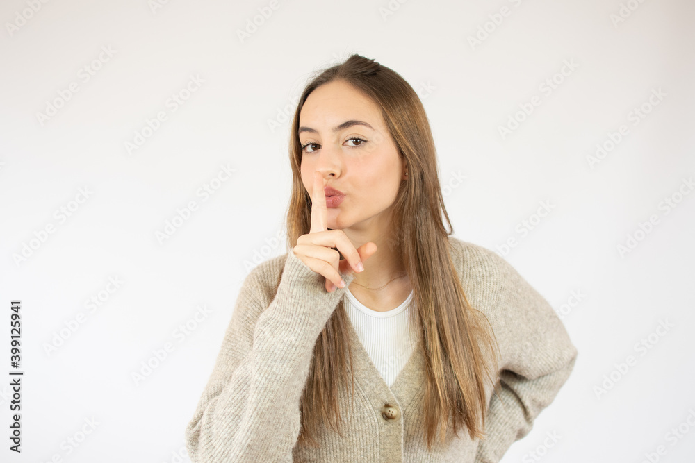Portrait of beautiful and young caucasian woman standing over isolated white background asking to be quiet with finger on lips. Silence and secret concept. Portrait of beautiful and young caucasian woman standing over isolated white background asking to be quiet with finger on lips. Silence and secret concept.