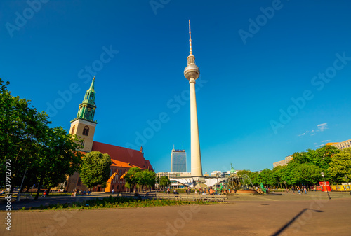 The Berliner Fernsehturm (Berlin TV Tower) and St. Marienkirche (St. Mary's Church) in Berlin Mitte on a May day.