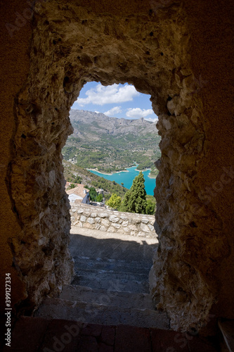 Archway looking to the reservoir and mountains at Guadalest, Alicante, Spain