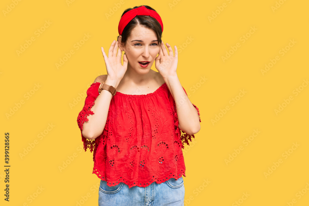 Young brunette woman with short hair wearing casual summer clothes and diadem trying to hear both hands on ear gesture, curious for gossip. hearing problem, deaf Young brunette woman with short hair wearing casual summer clothes and diadem trying to hear both hands on ear gesture, curious for gossip. hearing problem, deaf