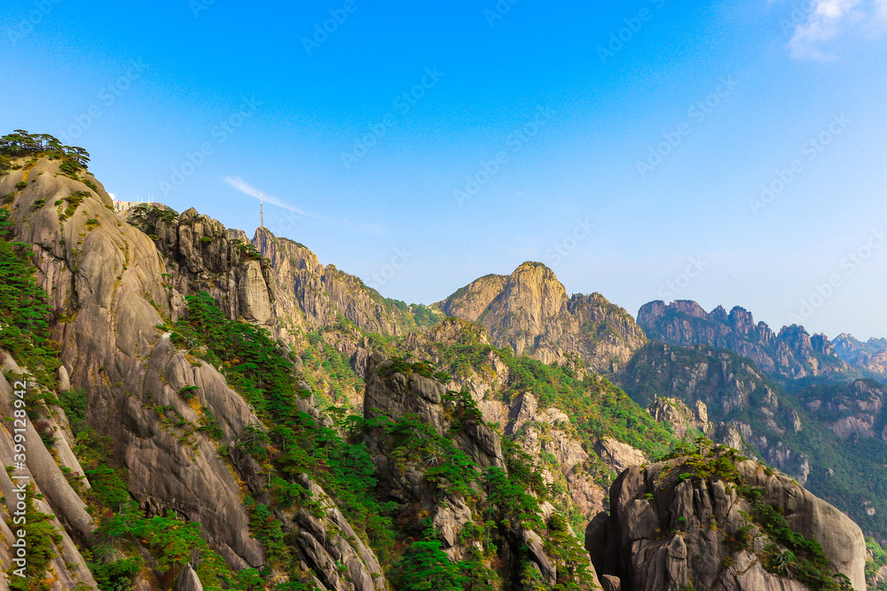 Scenic and panoramic view of 
Mount Huangshan cliffs and forest of Masson pine with various colours typical of the autumn season, Anhui, China Yellow mountain