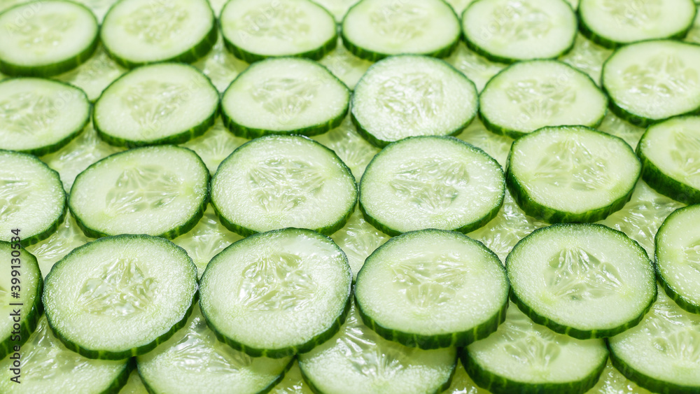 Fresh green slices of cucumber as background. Fresh green slices of cucumber as background.