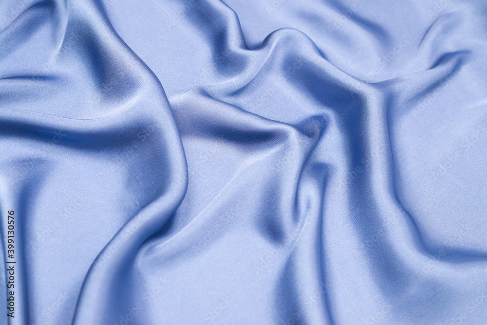 Obraz premium Blue silk or satin luxury fabric texture. Top view.