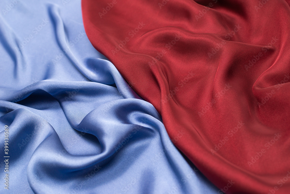 Red and blue silk or satin luxury fabric texture. Top view. Red and blue silk or satin luxury fabric texture. Top view.