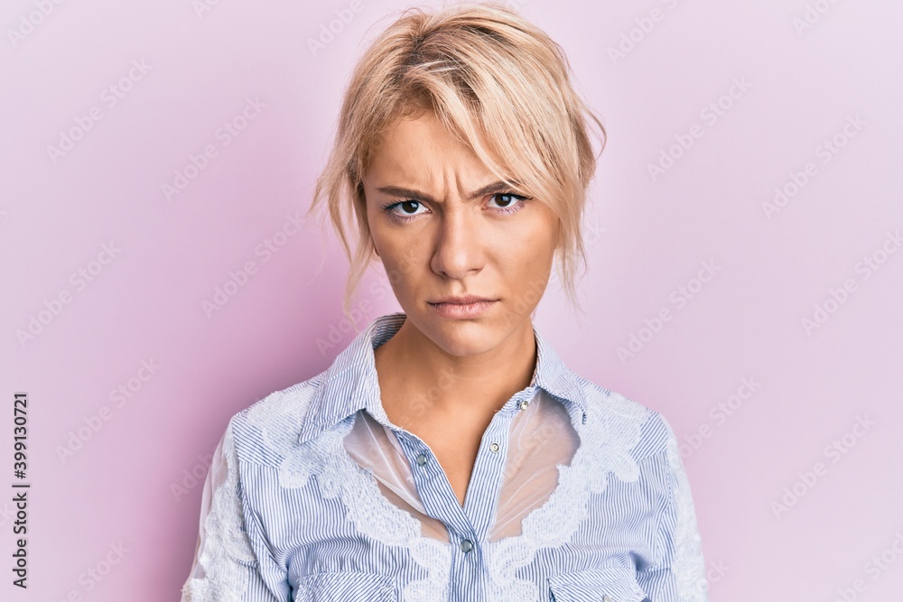 Young blonde girl wearing casual clothes skeptic and nervous, frowning upset because of problem. negative person.