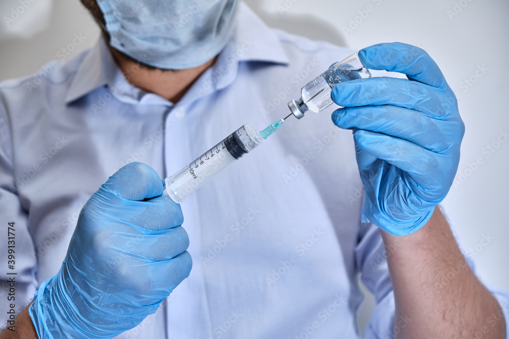Pandemic concept, close up of scientist injecitng vaccine. Treatment studies for diseases caused by the virus. producing vaccines for disease treatment. vaccine production processes for coronavirus. Pandemic concept, close up of scientist injecitng vaccine. Treatment studies for diseases caused by the virus. producing vaccines for disease treatment. vaccine production processes for coronavirus.