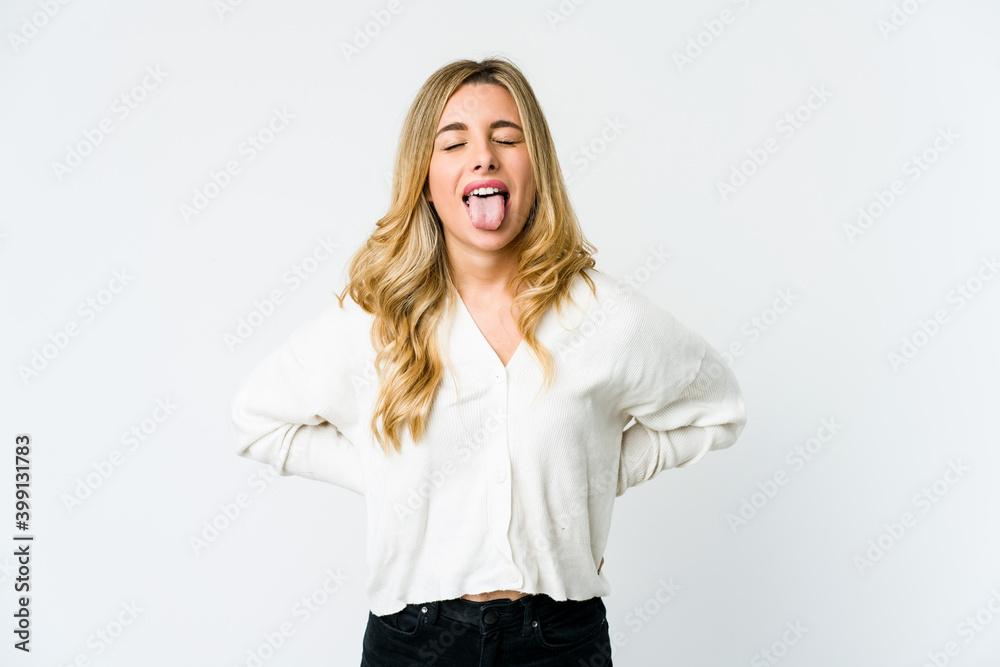 Young caucasian blonde woman funny and friendly sticking out tongue. Young caucasian blonde woman funny and friendly sticking out tongue.
